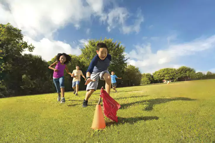 Y camp kids playing capture the flag