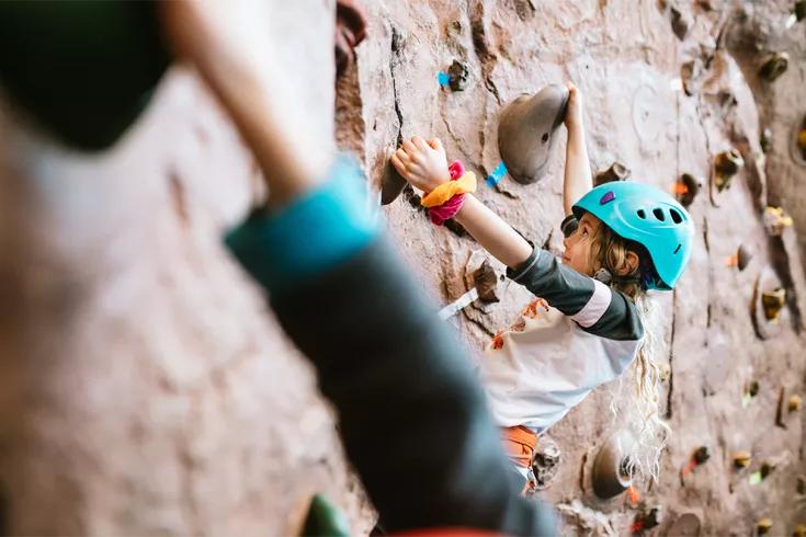 Child climbing a rock wall